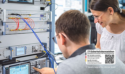 Employees stand in a server room