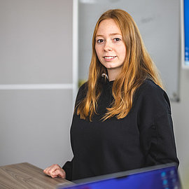 Trainee stands in front of the board