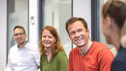 Conversation among colleagues in a chair circle for casual exchange