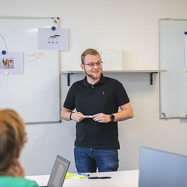 Trainee standing in front of a whiteboard