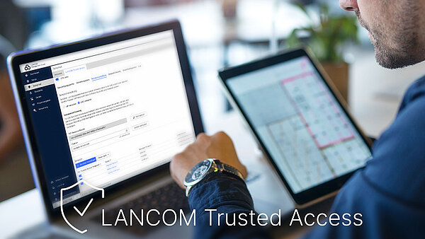 Man at the laptop with LANCOM Management Cloud Dashboard and LANCOM Trusted Access lettering
