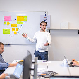 Trainee stands in front of a whiteboard