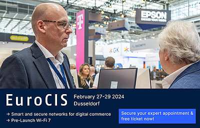 Advertising banner with photo of LANCOM employee with glasses giving friendly advice to a customer at EuroCIS and dark blue bar underneath including the inscription "EuroCIS, February 27-29, 2024, Düsseldorf, smart and secure networks for digital retail, pre-launch Wi-Fi 7" and button next to it: "Secure expert appointment and free ticket now"