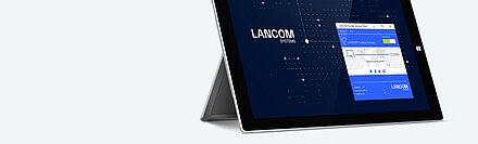 Banner image with a MacBook set up, showing the user interface of the LANCOM Trusted Access Client