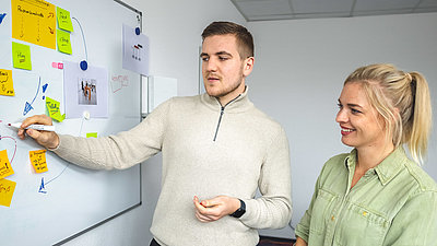 Studying at LANCOM Two students working together on the whiteboard