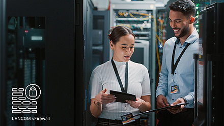 Two employees are standing in a server room, next to them is the icon of the LANCOM vFirewall