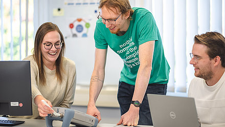 Young employees show something on the laptop