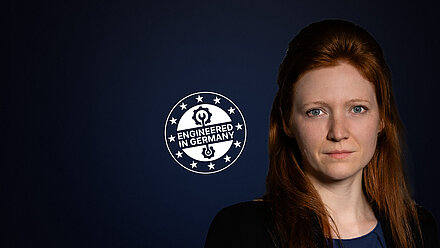 Jessica Strobl naast een "Engineered in Germany"-zegel op een donkere achtergrond