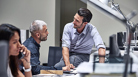 Two people discussing at a desk