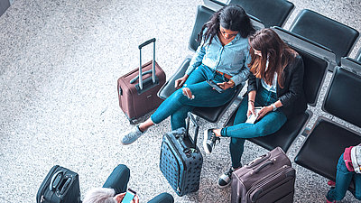 Photo of two women using mobile devices