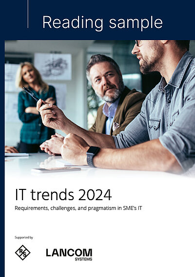 Cover image of the English techconsult and LANCOM study "IT trends 2024: Requirements, challenges, and pragmatism in SME's IT": Side view of two middle-aged men in elegant everyday clothes discussing a topic at a conference table, while a standing blonde colleague in the background watches them intently