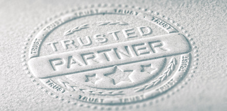 Trust and legal certainty wit LANCOM SD-WAN Stamp imprint on paper with inscription "Trusted Partner"