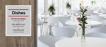 LANCOM Wireless ePaper Display being used as a menu A LANCOM Wireless ePaper Display being used as a menu. On the right-hand side, one can see an empty dining room. In the room, there are white chairs as well as white tables that are decorated with flowers.